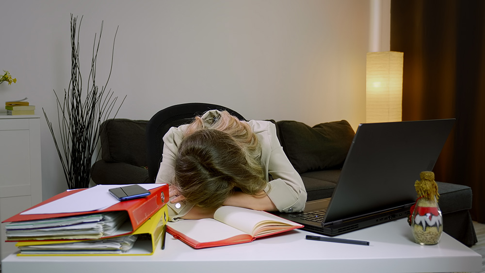 Business Woman Sleeps On Desk