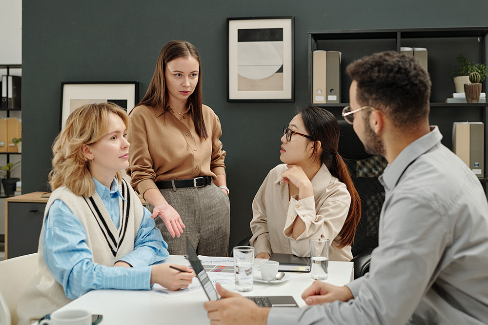 Female Boss Talking To Employees